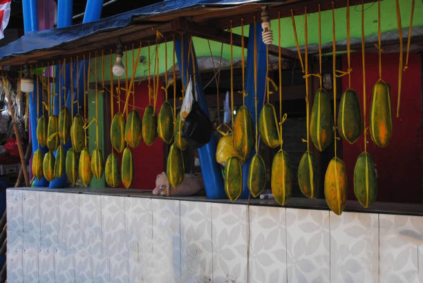 istock Hanging papayas  in the traditional fruit market. 1611839947