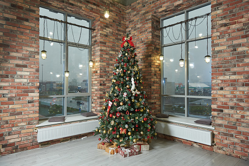 Christmas interior in the living room with brick walls.