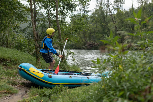 istock Father and son kayaking on the river Kolpa 1611873282