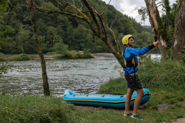 istock Father and son kayaking on the river Kolpa 1611873795
