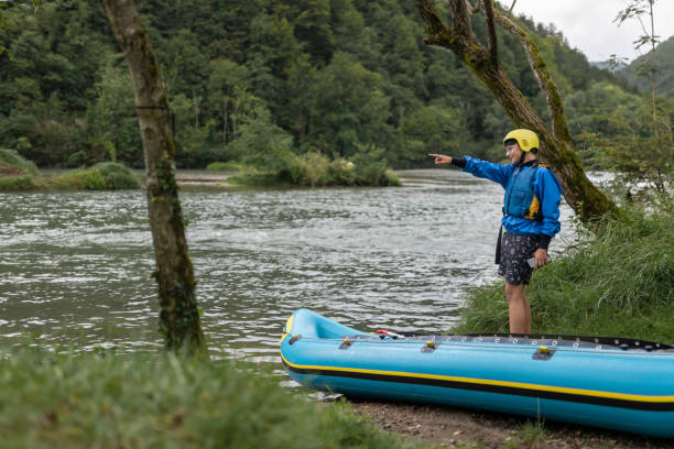 istock Father and son kayaking on the river Kolpa 1611873804