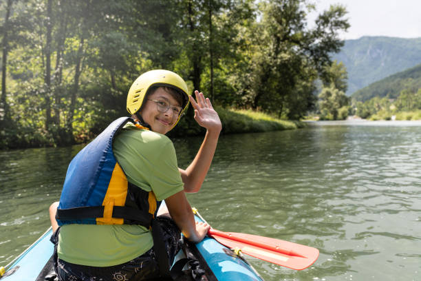 istock Father and son kayaking on the river Kolpa 1611873814