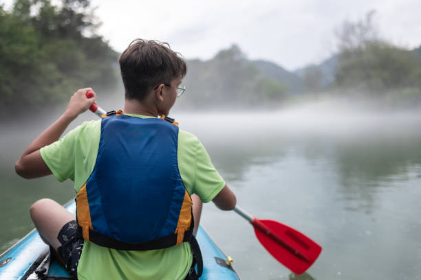 istock Father and son kayaking on the river Kolpa 1611874345
