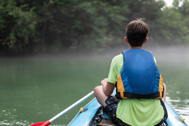istock Father and son kayaking on the river Kolpa 1611874351