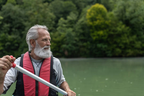 istock Father and son kayaking on the river Kolpa 1611874893