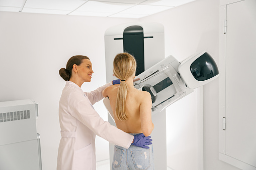 Woman doing mammogram x ray for breast cancer prevention screening at hospital