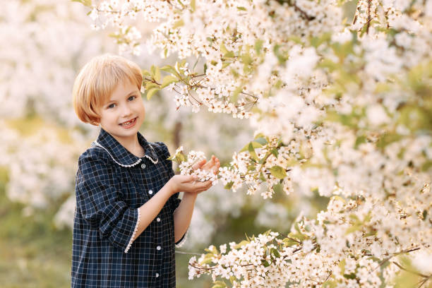 istock Girl in blooming apple orchard 1611875424