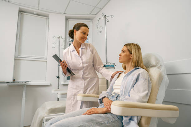 istock Nurse or doctor talking with patient while preparing her for infusion drip in hospital 1611885165