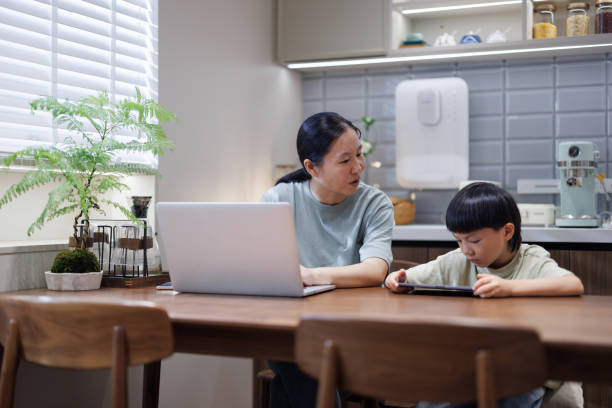 istock asian women at work are tutoring their sons in online learning 1611891501