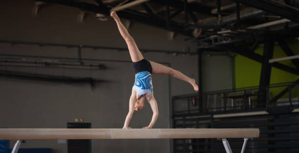 istock Female Gymnast On Balance Beam 1611908430