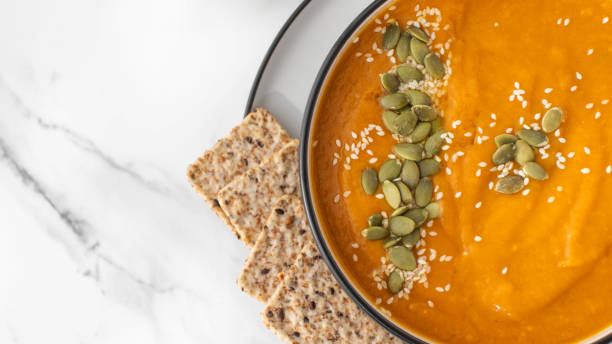 istock A bowl of pumpkin soup with mashed potatoes and seeds. Autumn menu. Copy space 1611959183