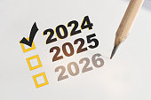 New year check list box with check mark in year 2024 on white paper with pencil