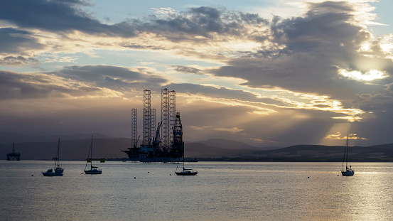 Oil rig awaiting decommissioning, moored in the shallow waters of the Cromarty Firth in Scotland.