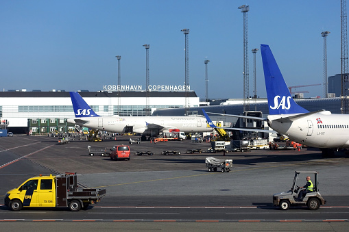 The Scandinavian airline, SAS, airplanes on the ground on a sunny day in Copenhagen, Denmark.