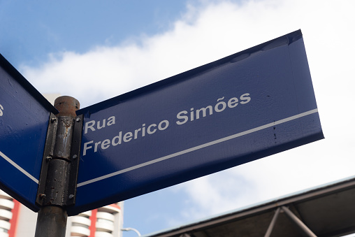 Salvador, Bahia, Brazil - August 11, 2023: Traffic sign indicating Rua Frederico SimÃµes near Avenida Tancredo Neves in Salvador, Bahia.
