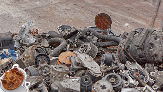Big bunch of old rusty used car parts for recycling junk yard