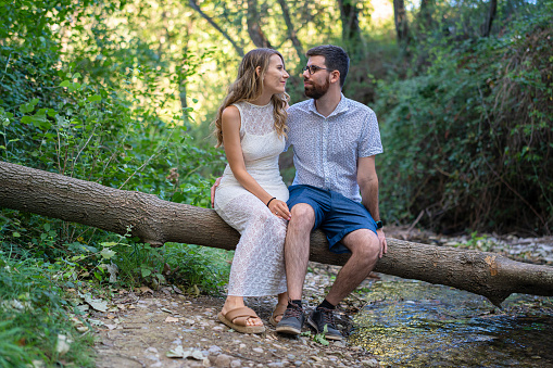 Couple in love enjoying a walk in the woods at sunset