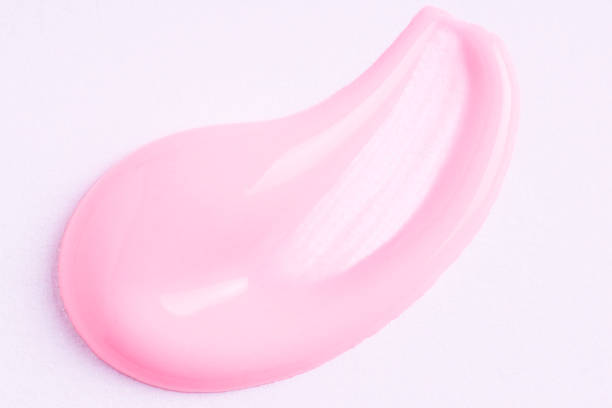 istock Pink cosmetic cream smear on white background. Face serum, lotion, moisturizer on white. Light pink paint swatch, macro. 1612109107