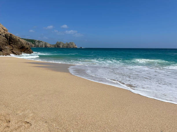 istock Sea lapping the golden sand 1612124279
