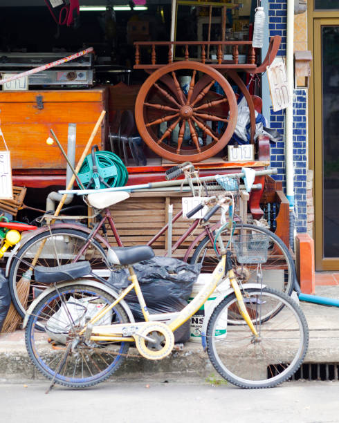 Open second hand store in Bangkok Senanikhom. Many utensils and old bicycles and some electronic pbjects are stacked for sale