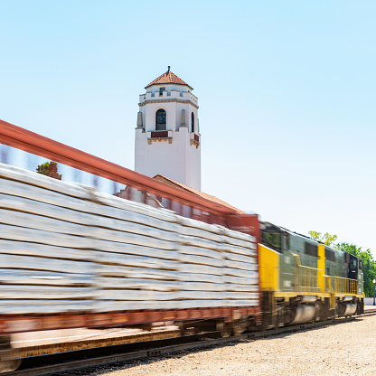 Fairfax Station, Virginia, USA - March 14, 2024: A Virginia Railway Express (VRE) commuter train travels on a curve heading Westbound on a sunny afternoon.