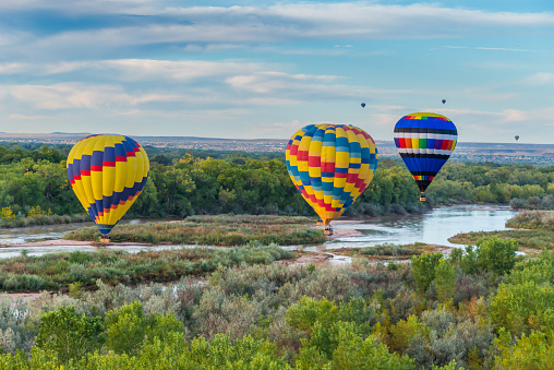 Hot Air Balloons flying over the Rio Grande near Albuquerque, New Mexico.Hot Air Balloons flying over the Rio Grande River.