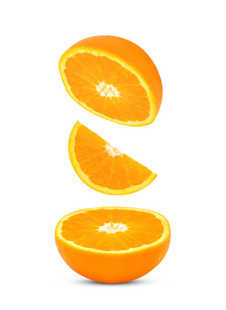 istock Slices of orange fruit falling in the air isolated on white 1612202478
