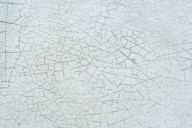 istock A surface cracked paint on the wall of an old building, bbstract texture and background 1612219931