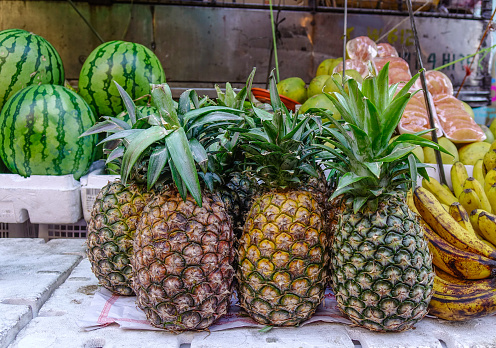 Selling pineapple fruits at rural market in Manila, Philippines.