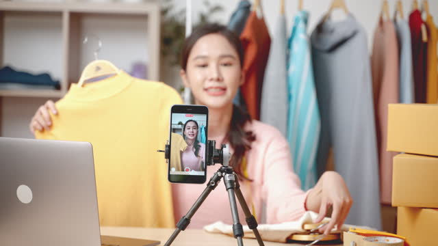 Asian businesswoman live-streamed ecommerce sell clothes at home,online business concept,startup business,business and communication technology