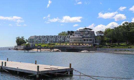 Bar Harbor, Maine, USA. June 14, 2022.  The stately Bar Harbor Inn and dock sitting at the edge of Frenchman Bay in this wildly popular tourist resort town.