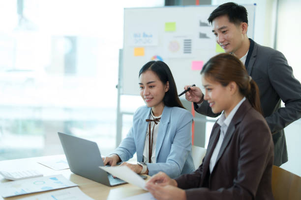 istock Group of business people sitting around a table and talking. 1612240639