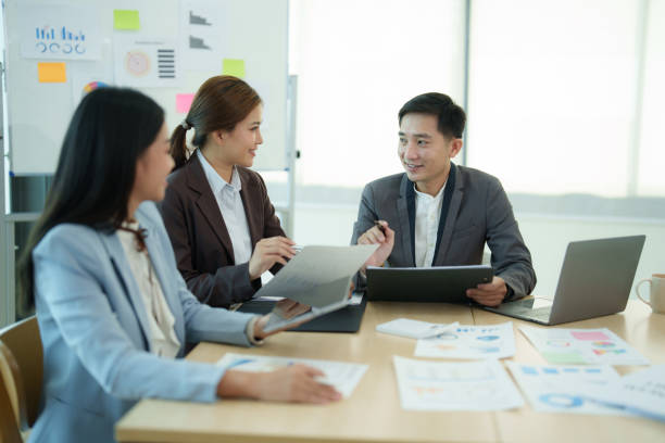 istock Group of business people sitting around a table and talking. 1612266255