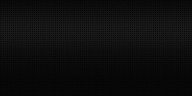 istock Abstract black perforated metal background texture 1612278100