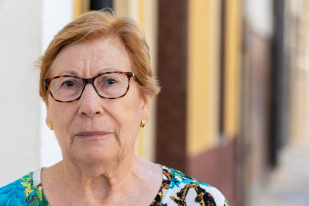 Elderly woman looking through optical  glasses
