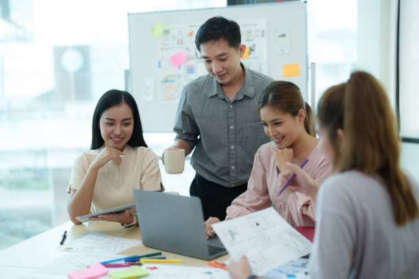 istock Group of asian creative teamwork discuss at business meeting for developing mobile phone app project, ux, ui start up, small business concept 1612310824