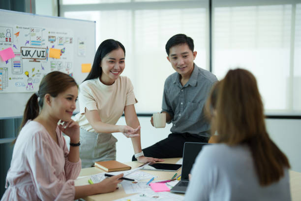 istock Group of asian creative teamwork discuss at business meeting for developing mobile phone app project, ux, ui start up, small business concept 1612318415