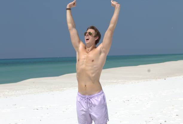istock Man yawning on the beach 1612340168