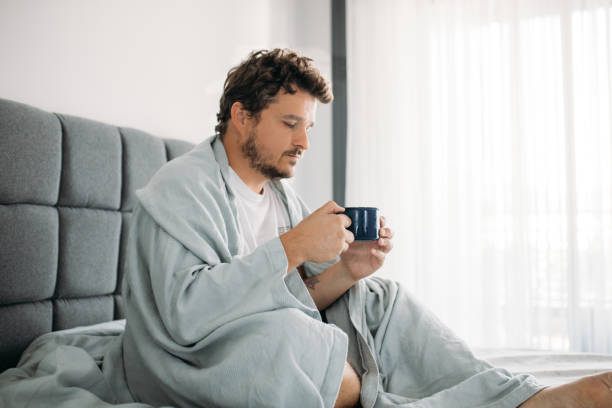 istock desperate man sitting on the bed and struggles with depression 1612344502