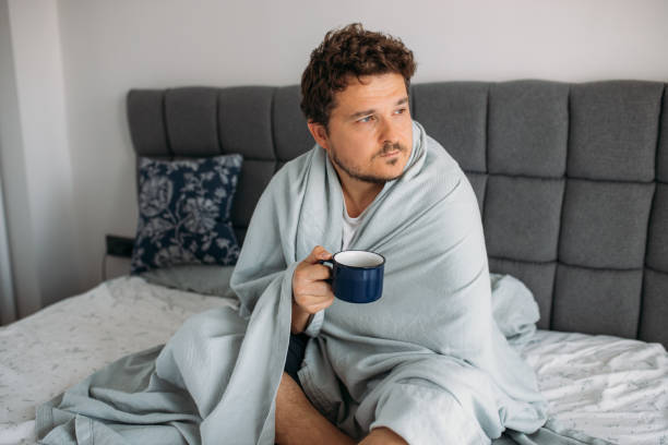 istock desperate man sitting on the bed and struggles with depression 1612347139