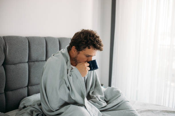 istock Sleepy Man drinking coffee for waking up in the morning 1612348730