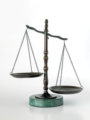 Still life of a scale of justice on white background