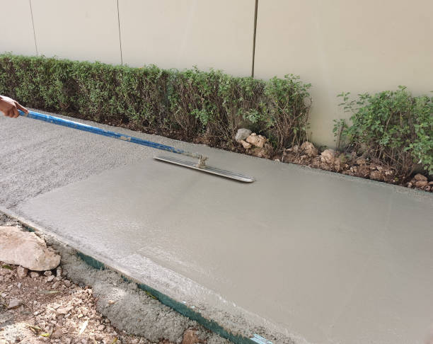 istock Worker level cement mortar. Construction worker uses trowel to level cement mortar screed. Concrete works on construction site 1612390403