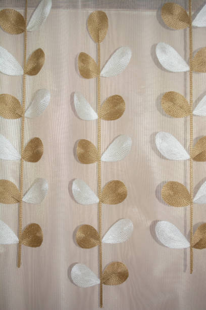 istock Background white tulle in a cage with white and brown leaflets 1612393055