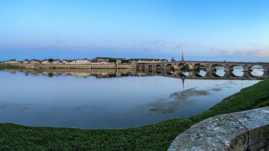 The stone bridge spans the Loire river in the middle of Blois, between the downtown  and Vienne on the left bank.