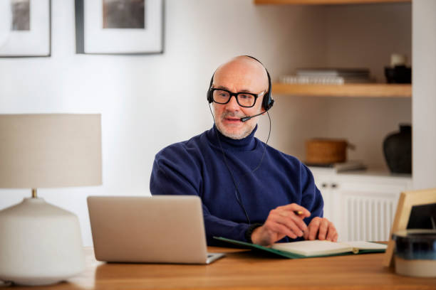 istock Male customer service assistant business man wearing headset and using laptop for work 1612420452