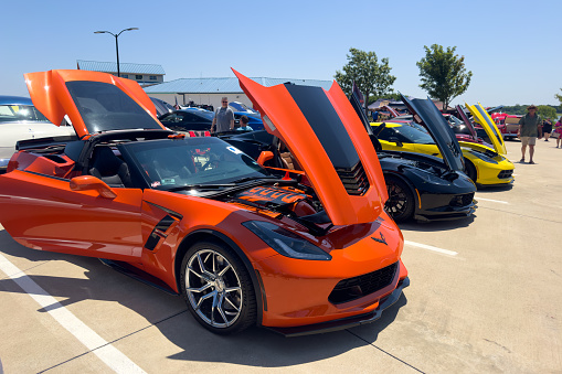 Little Elm, Texas - June 11, 2023: Orange and Black Chevrolet Corvette with hood open at local outside car show.