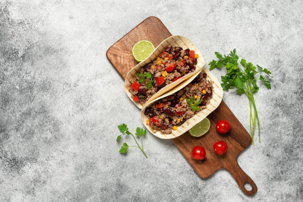 istock Mexican tacos with beef. Gray rustic background. Top view, flat lay. 1612429085