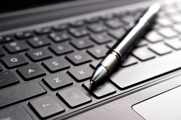 istock Closeup of pen on keyboard 1612436620