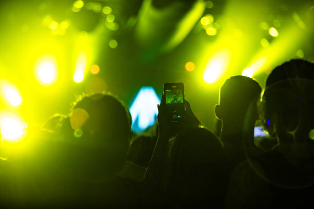 istock Hands holding phone and making photos on the concert. 1612470954